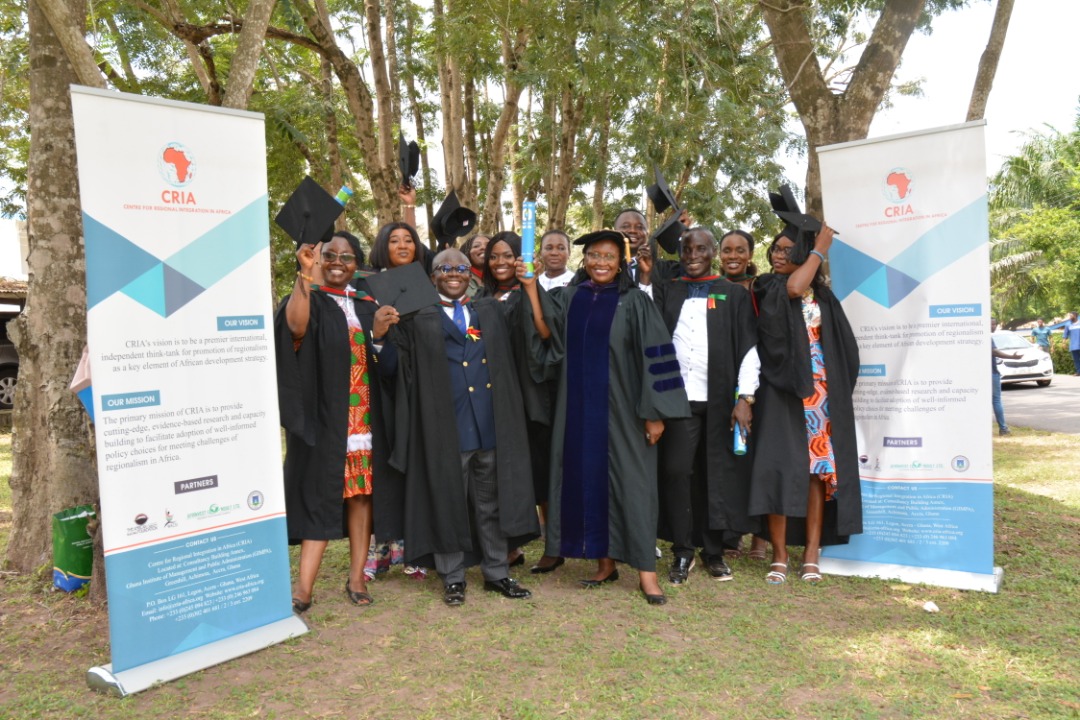 graduants holding hats high